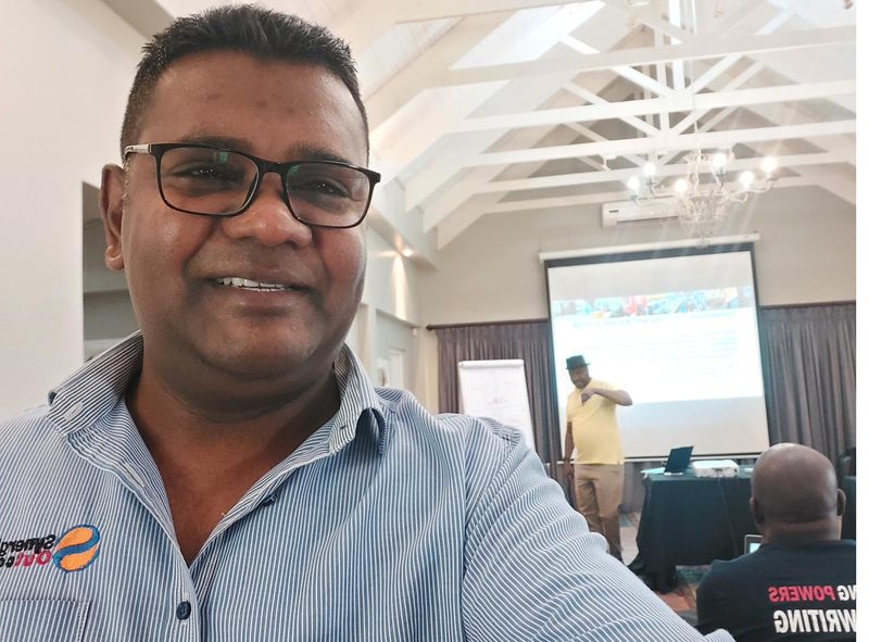 Anil Salick at a Synergistic Outcomes facilitation session, wearing branded shirt